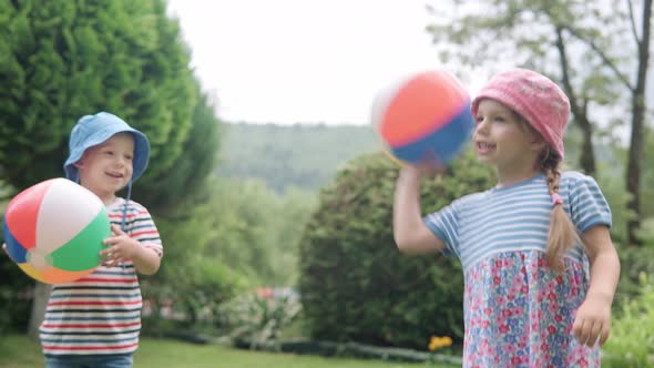 Happy Children Runing with MultiColor Beach Ball