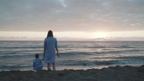 Mother And Baby Looking At Sea