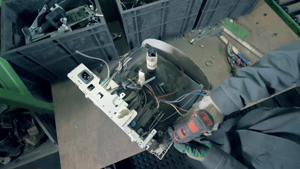 Male Worker Destroys Monitor for Recycling at Factory. Trash, E-waste, Electronic Garbage Recycling alt