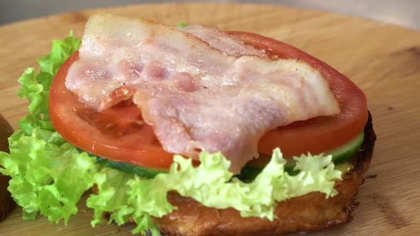 Making Burger Closeup the Hand of a Chef in Black Gloves Prepares a Burger or Cheeseburger with a alt