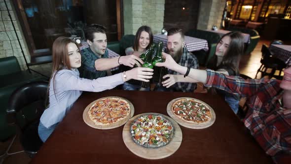 A Company of Friends at a Restaurant Drinking Beer and Talking alt