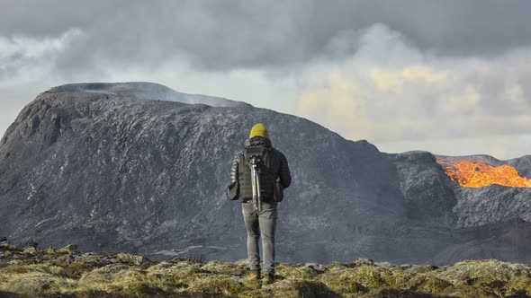 Man Walking Towards Lava Flow From Erupting Fagradalsfjall Volcano alt