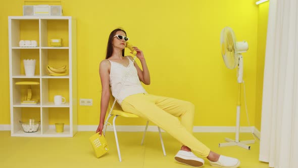 Woman Is Using Yellow Retro Telephone