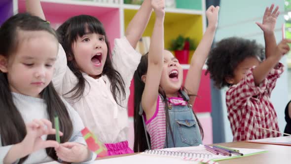 Group of children drawing in classroom, Multi-ethnic young boys and girls happy funny study. alt