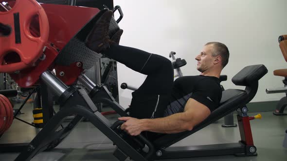 The Athlete Shakes His Legs on the Simulator  Slow Mo alt