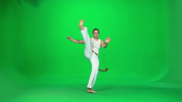Woman with Long Hair Practicing Capoeira on Chroma Key Studio. Slow Motion. alt