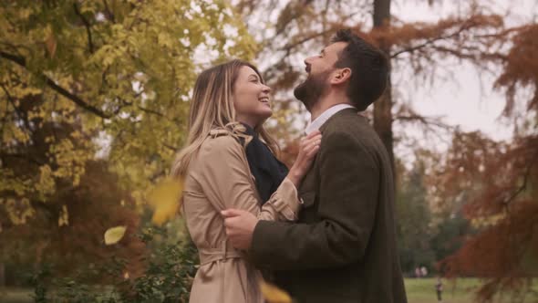 Handsome young couple walking in the autumn park