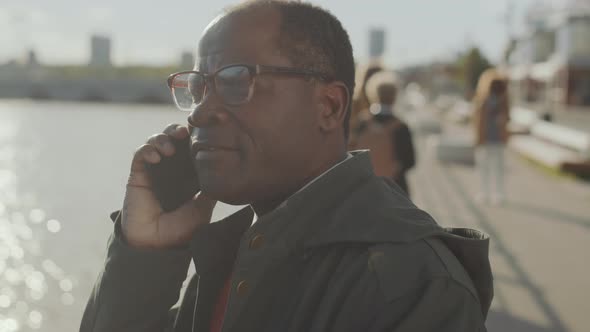 African American Man Talking on Phone on Urban Street alt