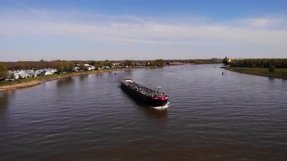 Tankship Travelling Across The River At Daytime. Shipping Vessel. aerial alt