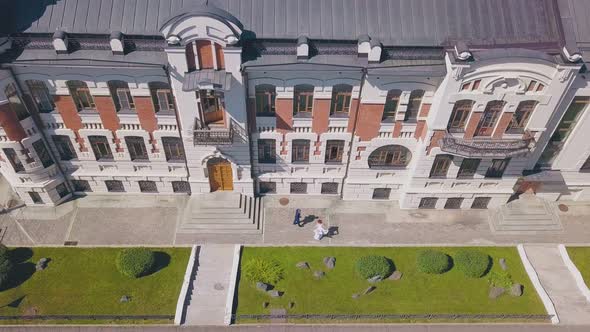Bride Dances and Walking Groom Watches on Street Aerial View alt