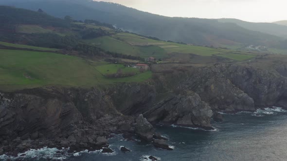 View of Bakio beach resort city and Gaztelugatxe, north rocky coast of Spain at sunset alt
