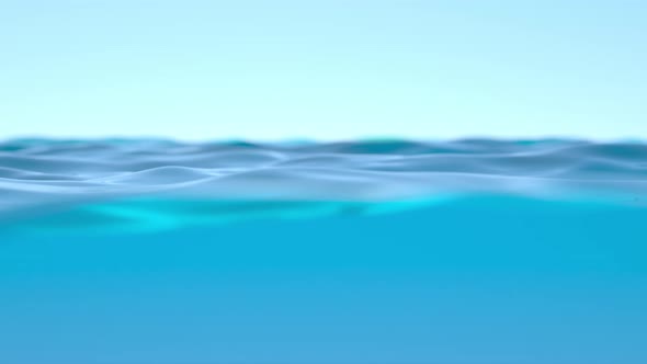 Blue Ocean Water Surface And Underwater With Sunny Sky