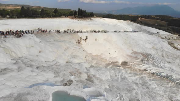 Visitors and Tourist People Walks Pamukkale's Calcium Carbonate Travertines