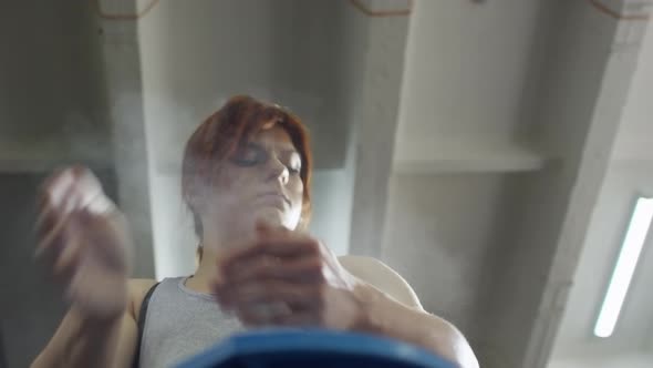 Sportswoman Chalking Hands alt