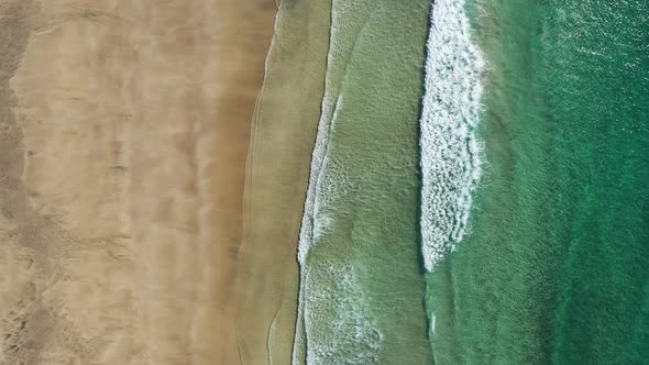 Top down view on the Lofoten beach and sea waves