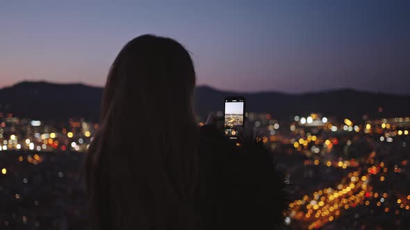 Unrecognizable Woman Making Photo of Night City Ob Smartphone Creating Content for Social Media alt