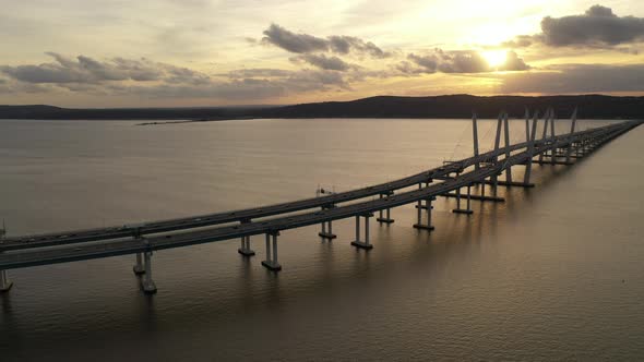 An aerial shot of the Mario M. Cuomo Bridge taken on the north side. The drone camera dolly out & bo alt