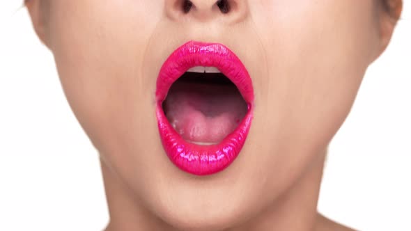 Extreme Closeup Portrait of Serious Woman Wearing Dazzling Pink Lipstick Expressing Shock with alt