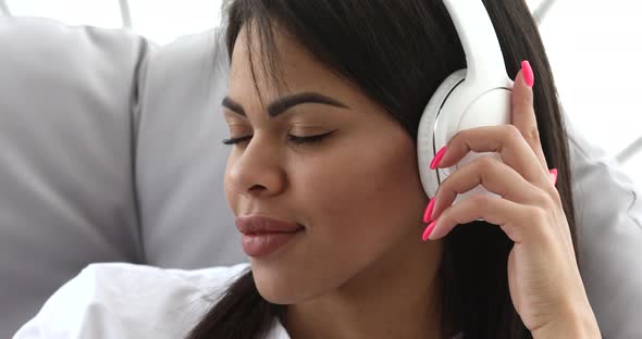 Black Woman listening music  at home.