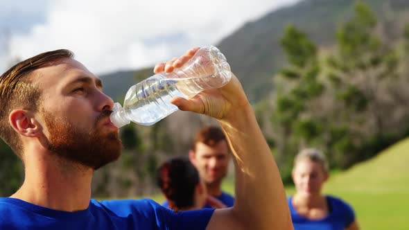 Man drinking water in boot camp alt