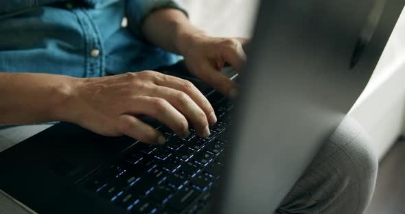 Woman Texting on Laptop