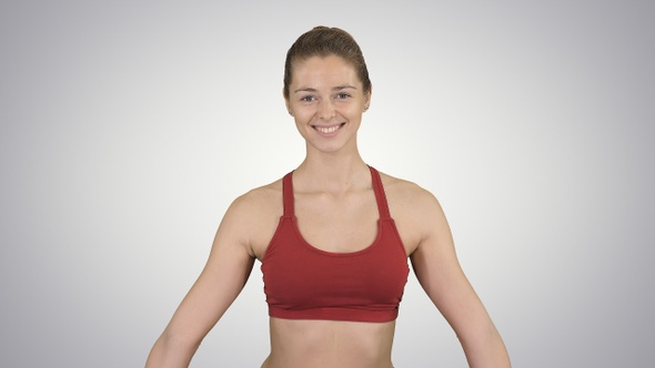 Young attractive woman practicing yoga sitting in Gomukasana alt