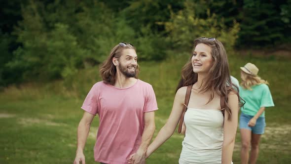 Friends Walking In Park. Happy Men And Women Having Fun