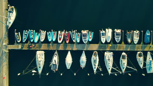 People Walking At The Jetty Between The Yachts And Sailboats Docked At The Marina Gdynia At Sunset I alt