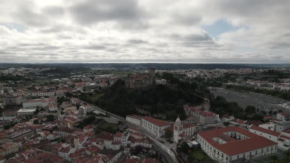 Leiria castle and surrounding landscape on cloudy day, Portugal. Aerial circling
