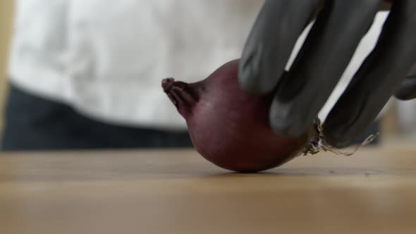 Chef cuts a red onion after turning it on the cutting board, Apple ProRes slow-mo alt