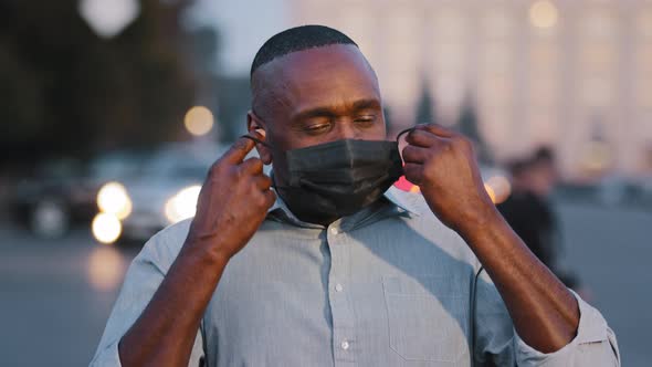 Adult Mature African American Man Takes Off Black Protective Medical Mask From Face Exhales Feels alt
