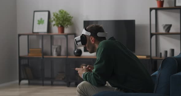 Crazy Gamer Is Playing Video Games Using Headmounted Display and Joystick Having Fun and alt