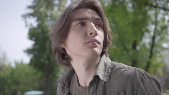 Close Up Portrait Lonely Nervous Young Man Sitting on the Bench in the Park Waiting for His Friend alt