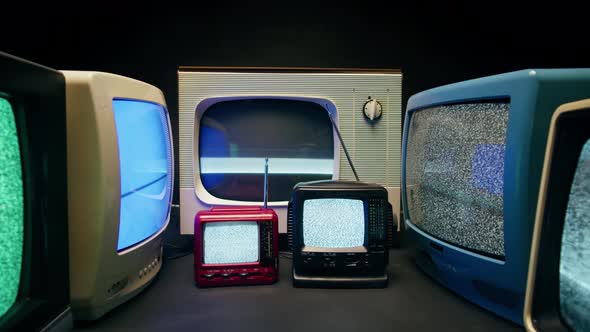 Old Televisions with Grey Interference Screen on Black Background alt