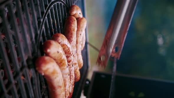 Meat Sausages are Fried on the Grill of the Street Grill