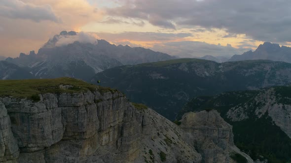Aerial view of hiker taking in magnificent scenery across South Tyrol dolomites Tre Cime extreme mou alt