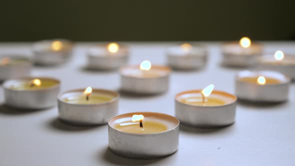 Tea Light Candles Are Being Magically Lit on Fire to Form the Shape of A Heart. Candles Baground.