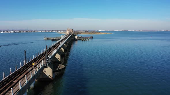 An aerial shot over Grassy Bay in Queens, NY. The camera dolly in along the length of the elevated t alt