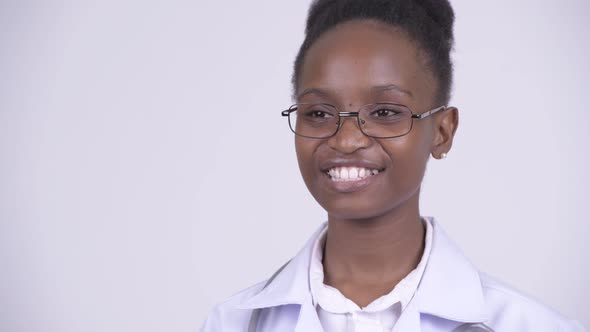 Face of Young Happy African Woman Doctor Thinking alt