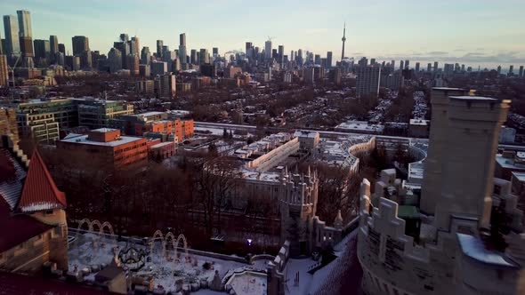 Exciting Aerial Reveal of Old Castle above Downtown Toronto at Sunset. Flying over the Turrets and R alt