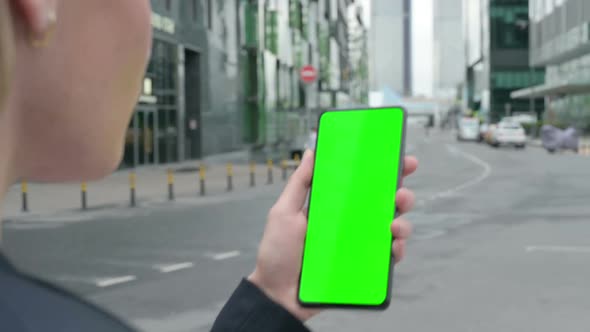 Businesswoman Using Smartphone with Green Chroma Screen alt