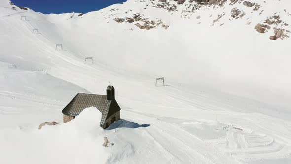 Chapel in snow-covered Mountains alt