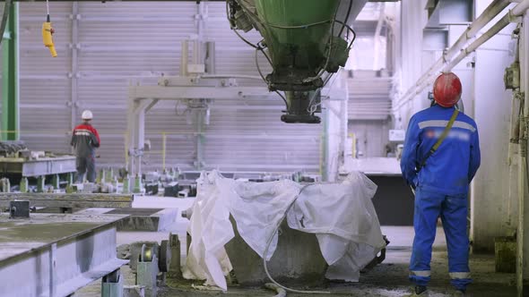 Factory worker standing near machine