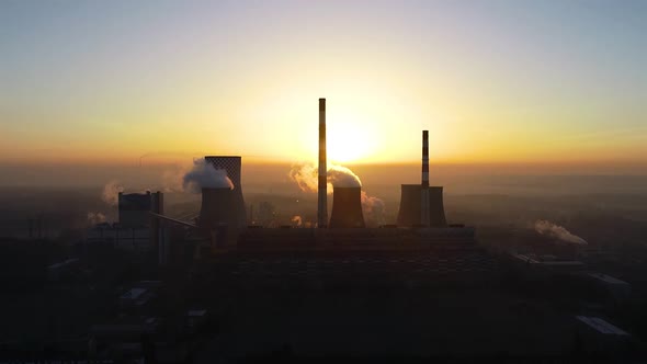 Aerial view of big powerhouse during sunrise. Big industry chimneys in power plant