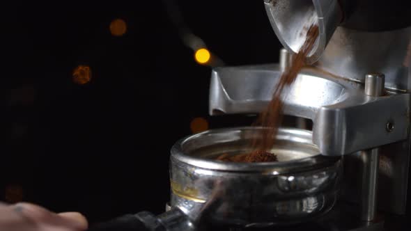 Barista Filling Portafilter with Freshly Ground Coffee alt