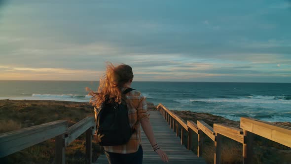 Young Female Traveler Run to Ocean at Sunset Beach
