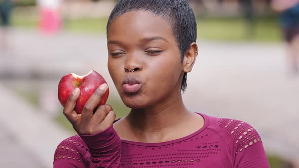 Beautiful Young Athletic Black Millennial Girl with Pleasure to Eat Delicious Apple Choose Wholesome alt