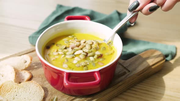 Homemade Vegetarian Pumpkin Cream Soup Served in Ceramic Bowl alt