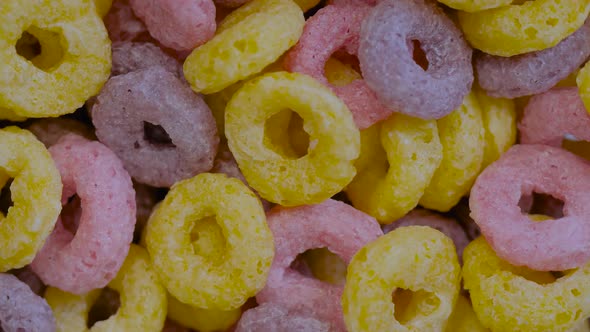 Top View Heap of Colorful Cereal Loop Rings on Rotating Surface  Close Up