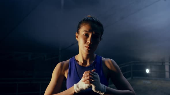 4K Portrait of Asian woman boxer practicing boxing exercise in abandoned building. alt
